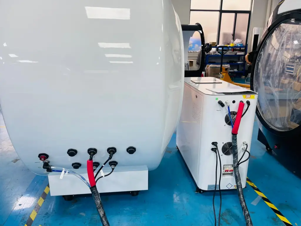 Rear of a hyperbaric oxygen chamber connected to its air supply and control unit