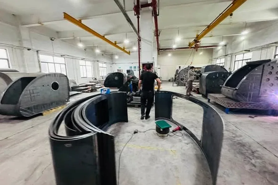 Curved stainless steel shell sections rolled in the workshop